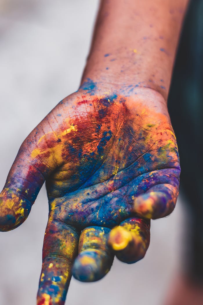 Vibrant painted hand showcasing artistic expression and creativity in vivid colors.